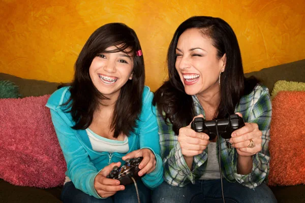 hispanic-woman-and-teenage-daughter-playing-video-game hispanic-woman-and-teenage-daughter-playing-video-game