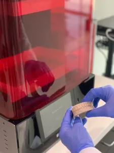 Printed Teeth Models in front of 3D Orthodontic Printer